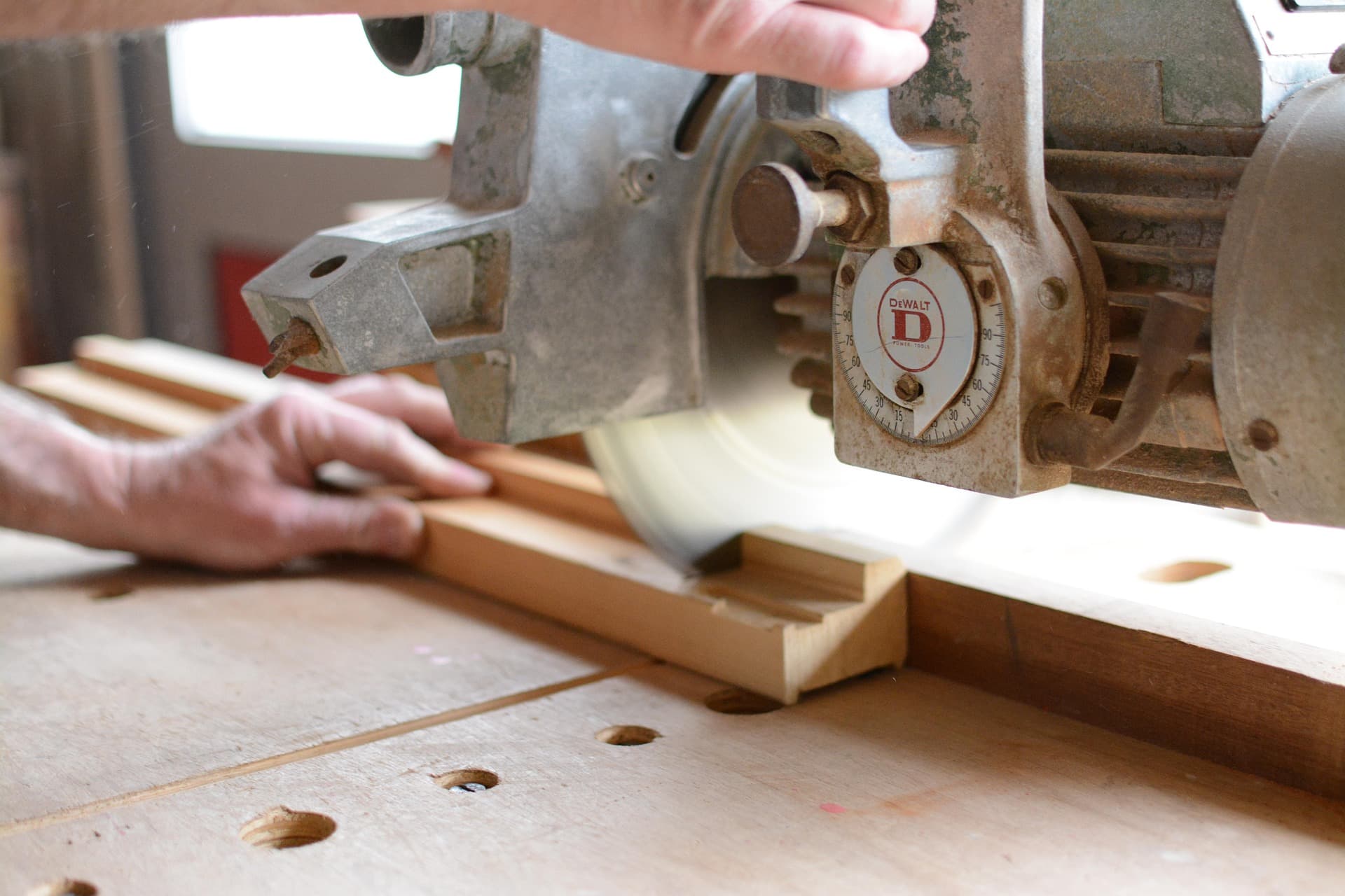 Carpenter sanding timber deck at construction site