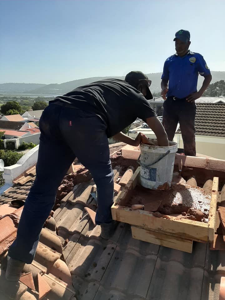 Carpenter installing timber cladding on a residential building
